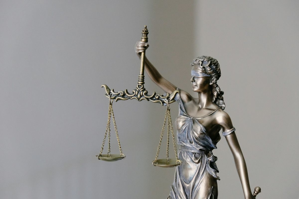 Bronze statue of Justice holding balanced scales